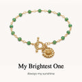 sunflower pendant emerald bracelet, meaningful symbolic jewelry